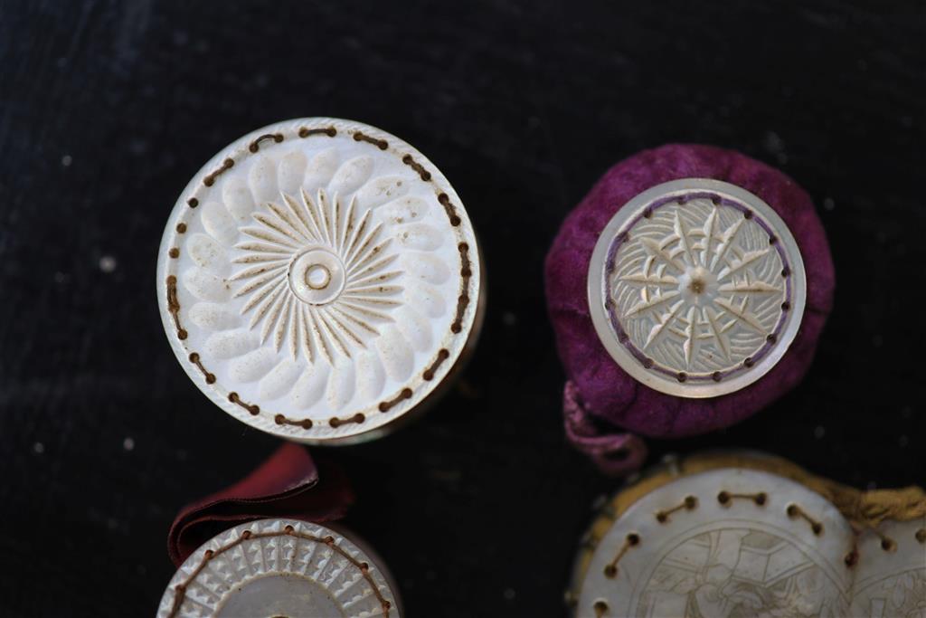 Eight assorted 19th century mother of pearl mounted pin cushions